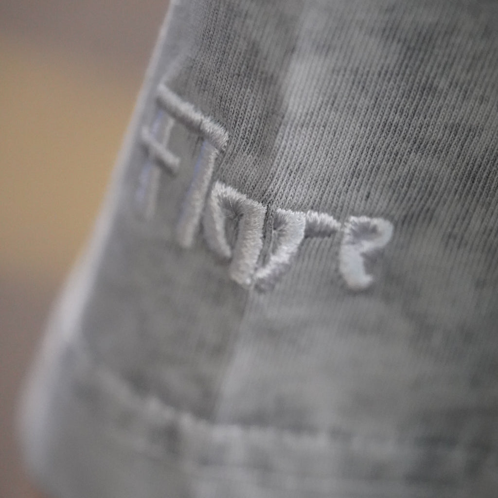 Close-up of the white Flare embroidery on the sleeve