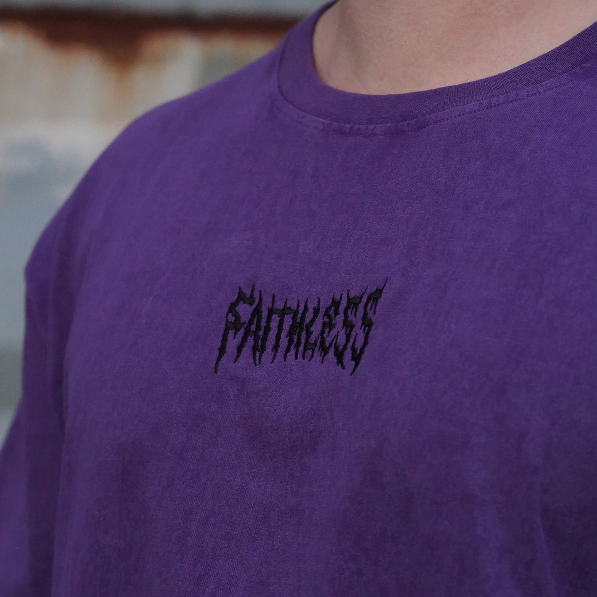 Close-up of the black Faithless chest embroidery on the Shadow tee